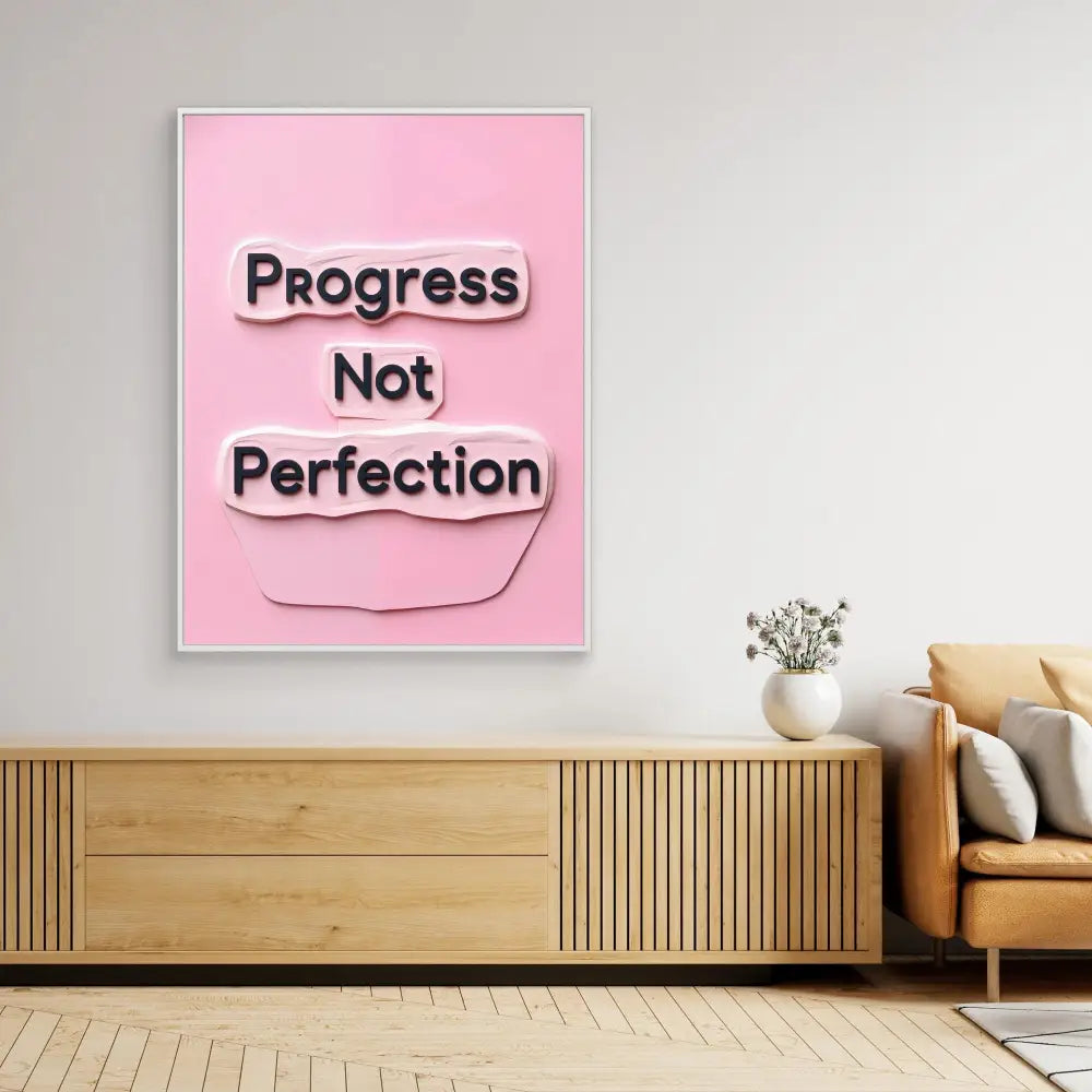 Pink motivational wall art displaying the text ’Progress Not Perfection’