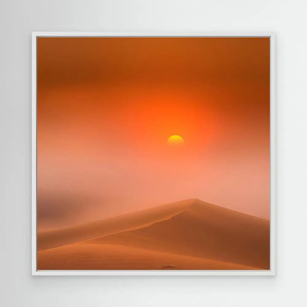 Sun setting over desert dunes in an orange-hued sky.