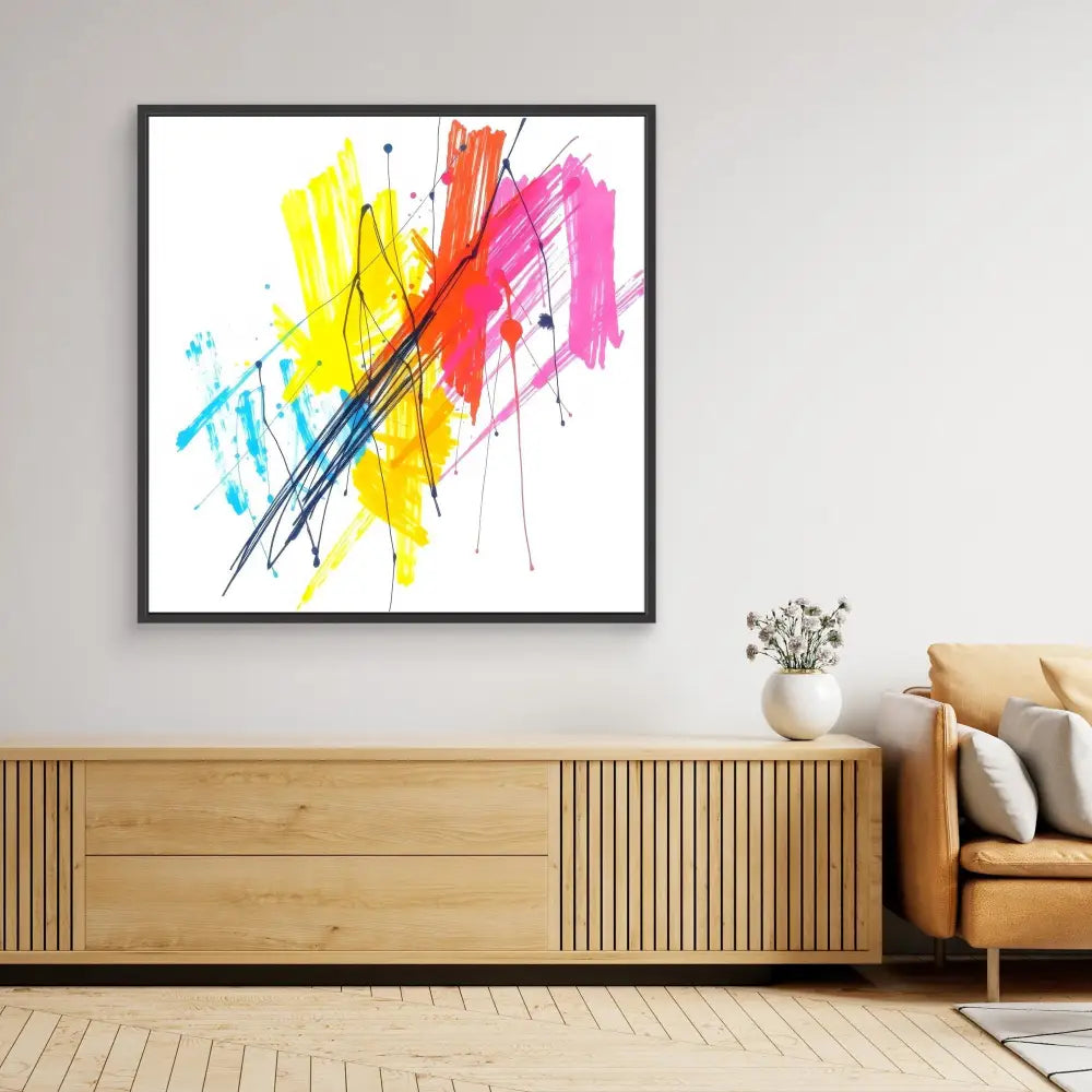 Vibrant abstract painting with yellow, red, pink and blue paint splashes crossed by diagonal black lines in a black frame.