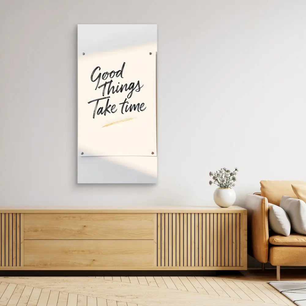 A wall-mounted motivational poster with the text ’Good Things Take Time’