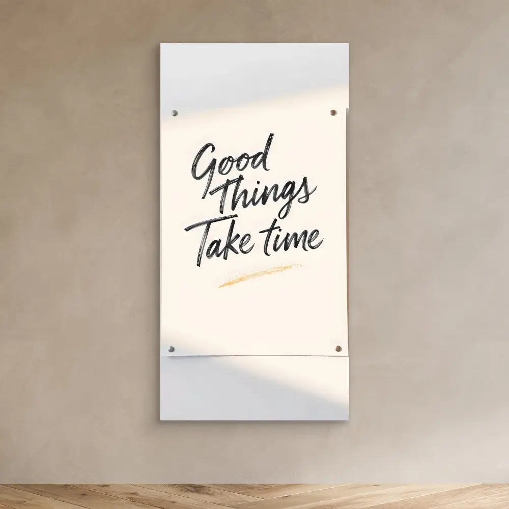 A white wall art piece displaying the handwritten text ’Good Things Take Time’